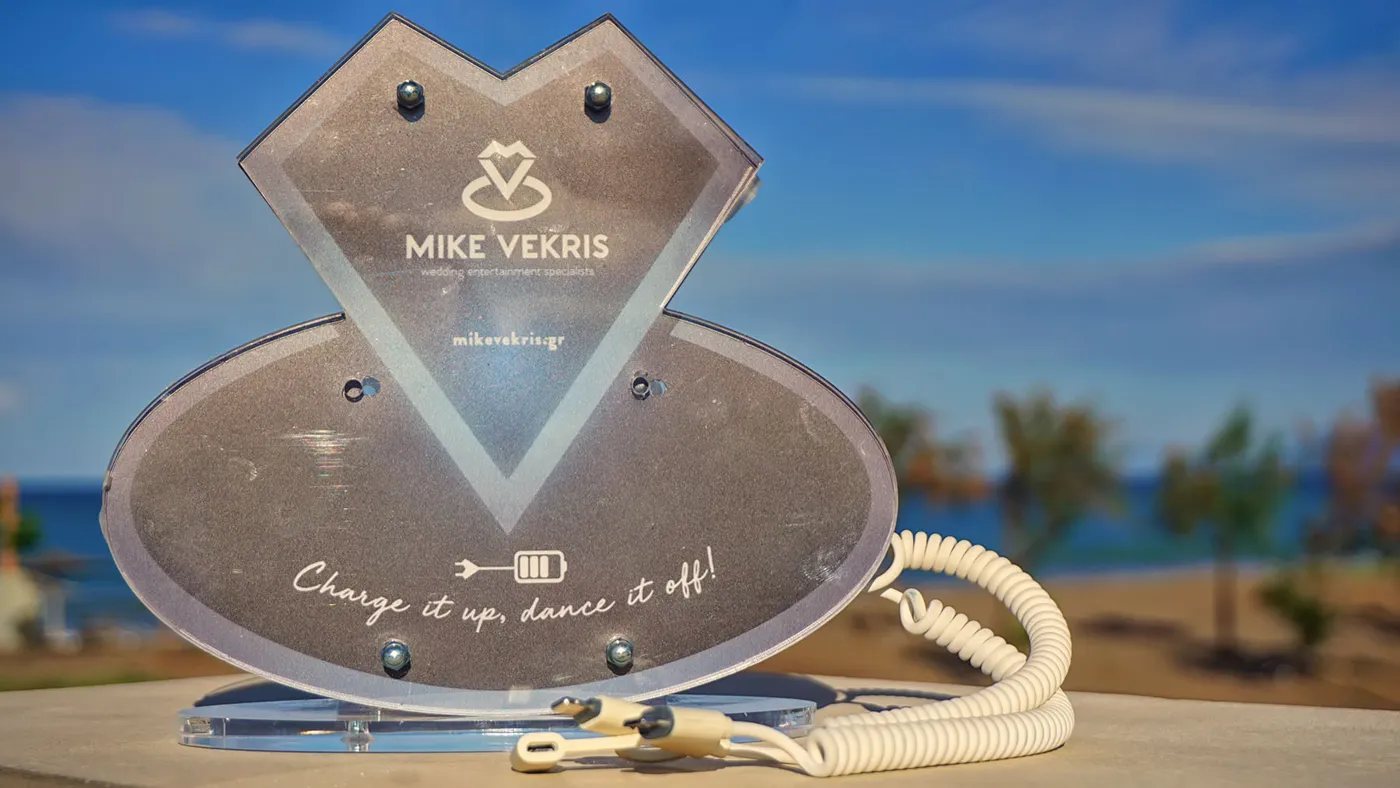 A phone charging station for wedding guests, on a table by the sea